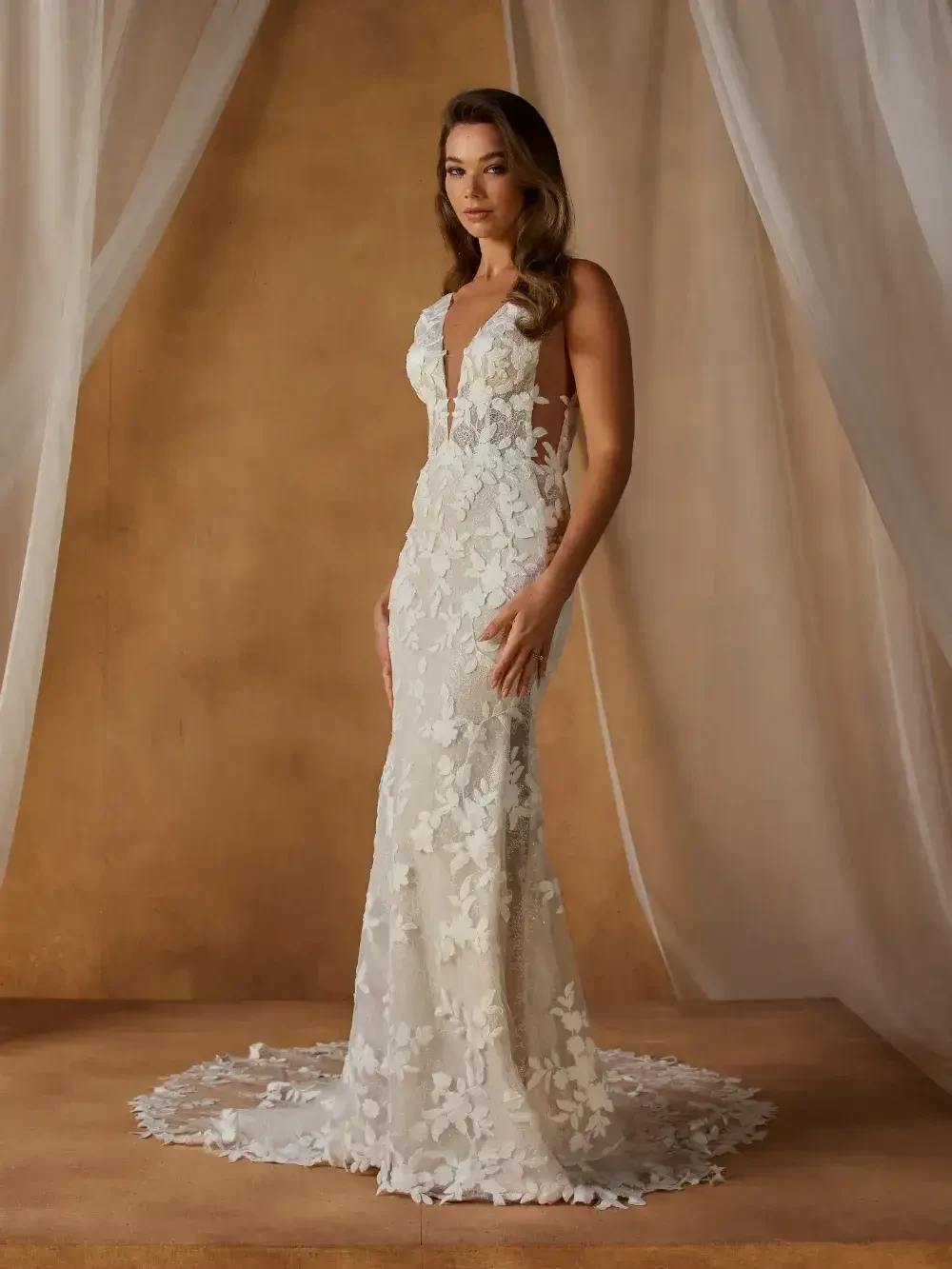 model is wearing a sleeveless lace fit and flare wedding dress
