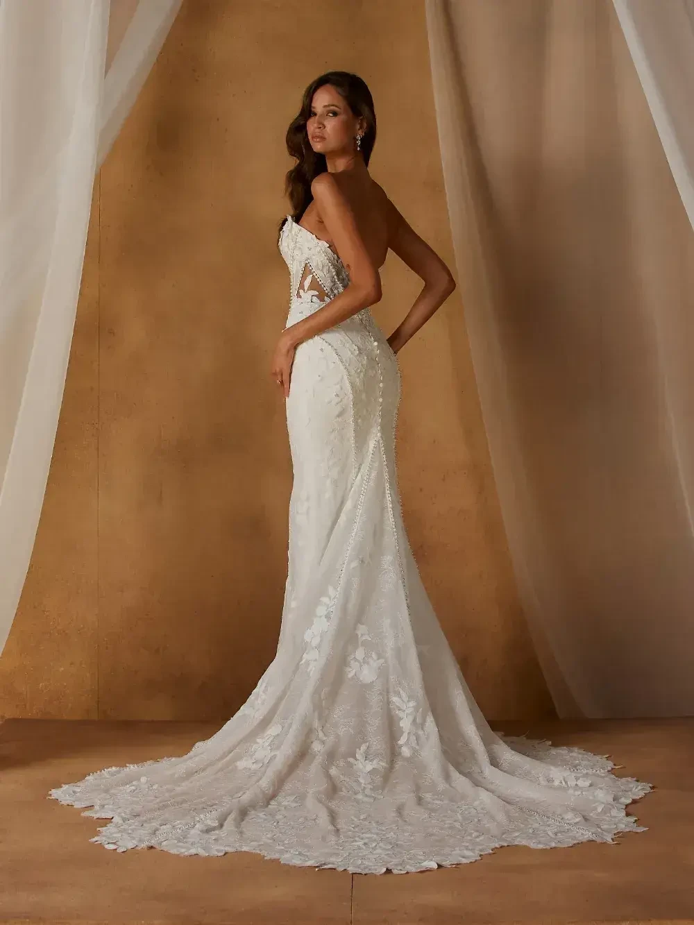 model is wearing a sleeveless fit and flare lace bridal gown
