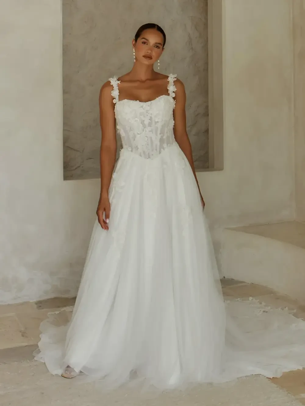 model is wearing a sleeveless a-line bridal gown