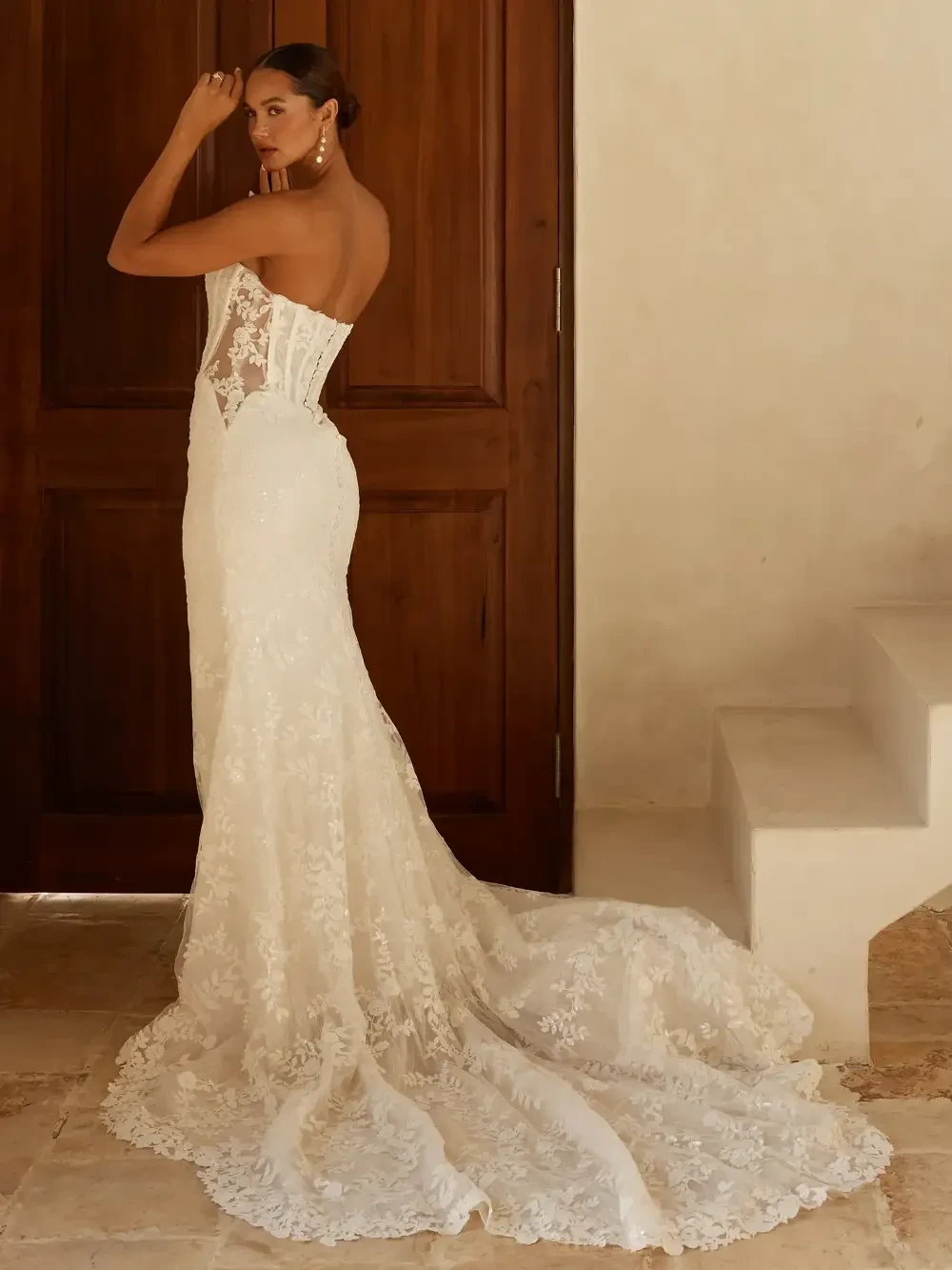 model is wearing a strapless fitted bridal gown