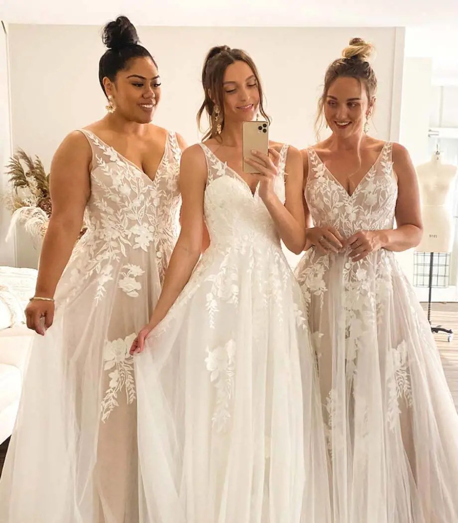 Models wearing a white dresses with phone